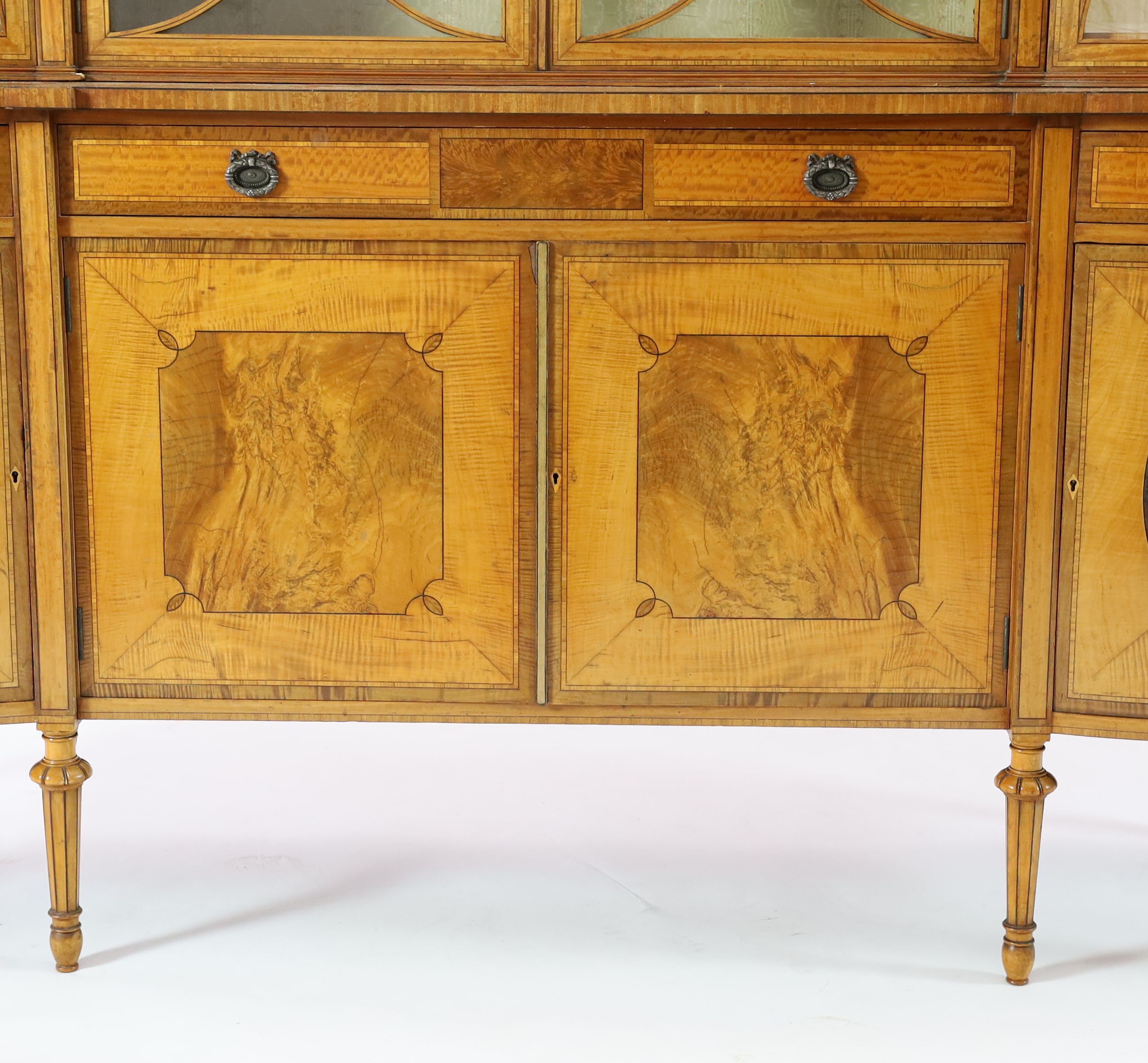 An Edwardian Sheraton revival ebony strung satinwood display cabinet, W.190cm D.47cm H.205cm